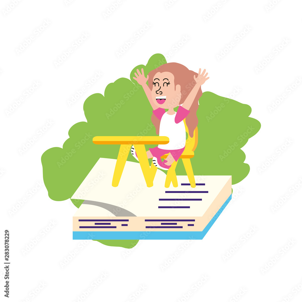 little student girl sitting in school desk with book