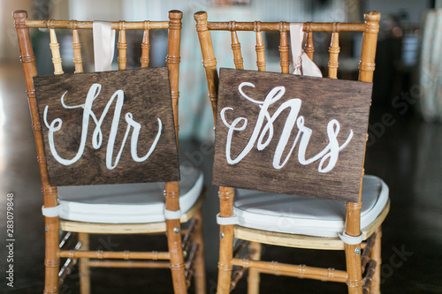 Bild auf Leinwand mr and mrs wooden signs on back of chair, wedding reception decor