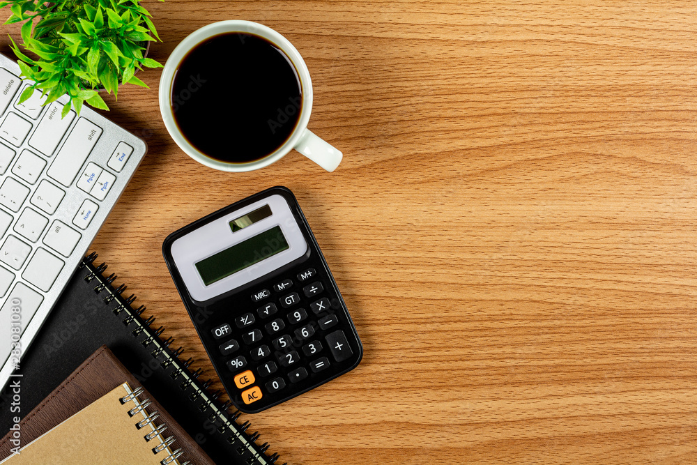calculator and office supplies on wooden table. - top view with copy space. calculator and office supplies on wooden table. - top view with copy space.