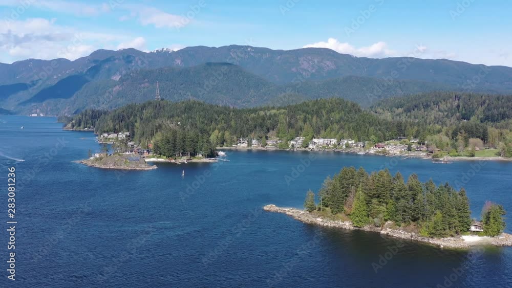 Aerial view over Burrard Inlet, ocean and island with boat and mountains in beautiful British Columbia. Canada. 4K. Aerial view over Burrard Inlet, ocean and island with boat and mountains in beautiful British Columbia. Canada. 4K.