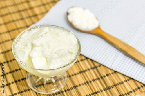 Natural homemade plain organic yogurt with wood spoon 