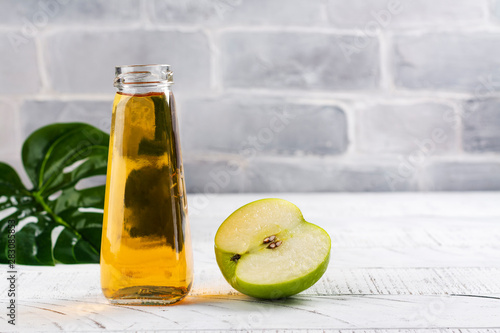 Fresh apple juice in a glass bottle photo