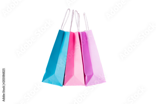 Three paper pink, purple,blue shopping bags isolated. Top view.