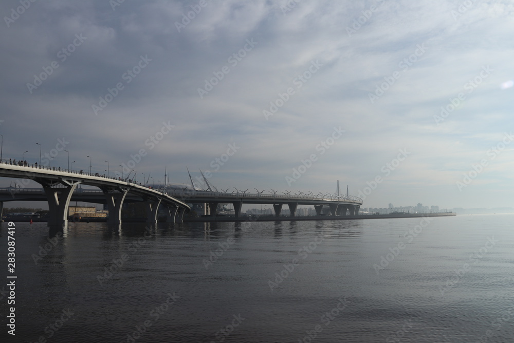 two winding highway bridges over the wide river with the fog futuristic view