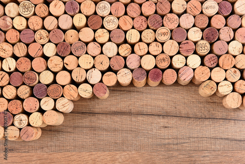 High angle shot of a group of wine corks on wood table with copy space