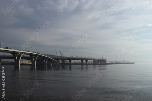 two winding highway bridges over the wide river with the fog futuristic view