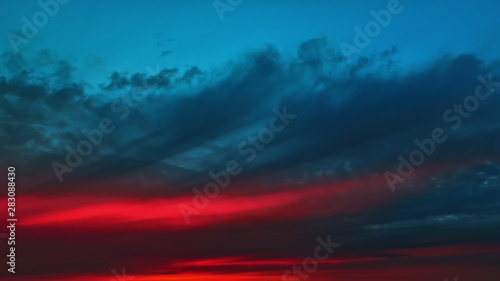 Colorful Red Glow On A Dark Cloudy Dramatic Sky