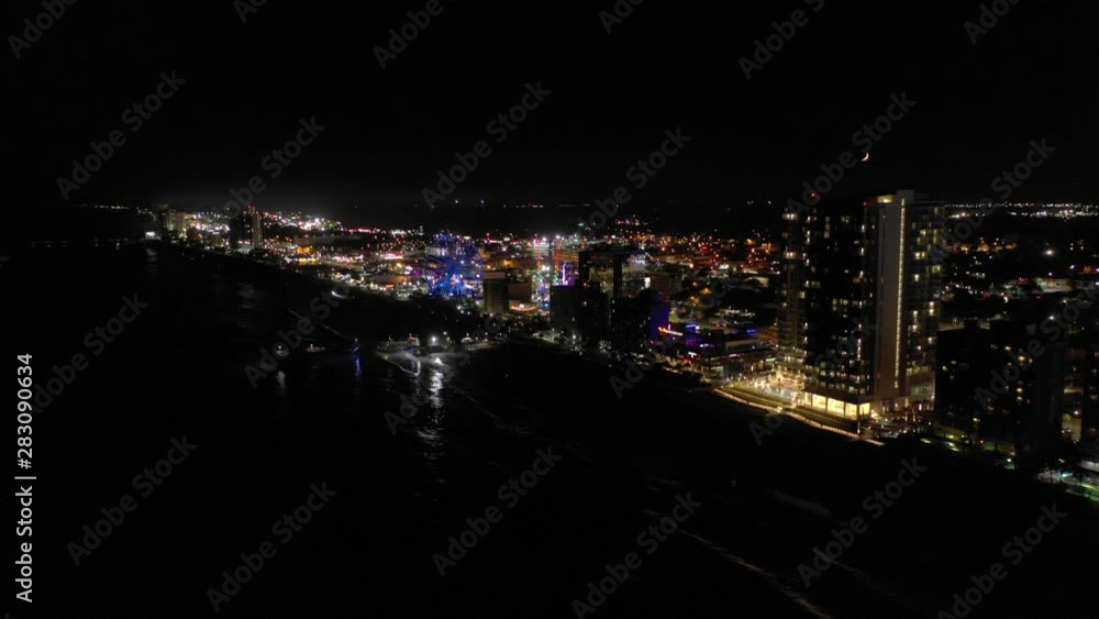 Aerial night approach Myrtle Beach South Carolina USA pier and skywheel Aerial night approach Myrtle Beach South Carolina USA pier and skywheel