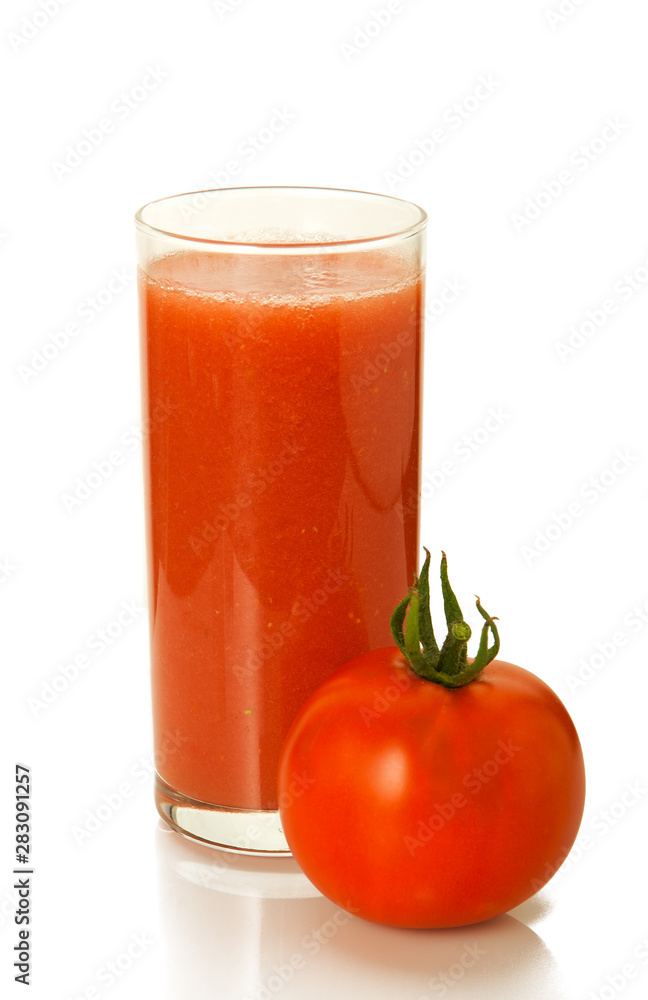Juice on isolate. A glass with tomato juice and fresh tomato. Juice on isolate. A glass with tomato juice and fresh tomato.