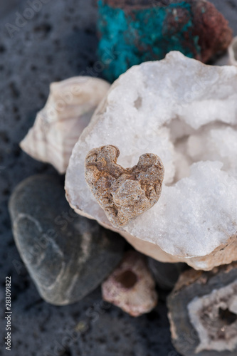 Stone beach heart rock sitting in meditation on a big Crystal Geode. 