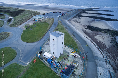 large white building near to rocks and the sea