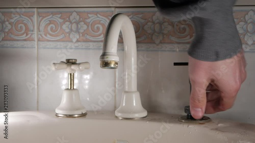 Handyman reseats a household faucet. Indoor plumbing, CLOSE UP