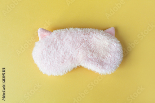 Wallpaper Mural Pastel pink fluffy fur sleep mask with small ears on pastel yellow paper background. Top view, flat lay. Concept of vivid dreams. Accessories for girls and young women Torontodigital.ca