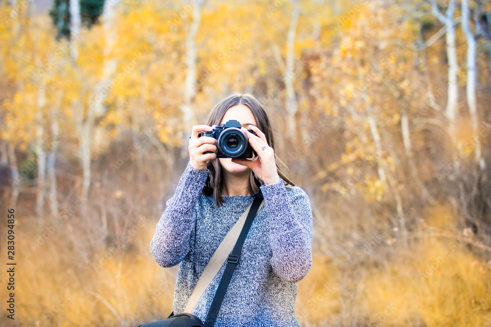 Young photographer in beautiful autumn meadow Young photographer in beautiful autumn meadow
