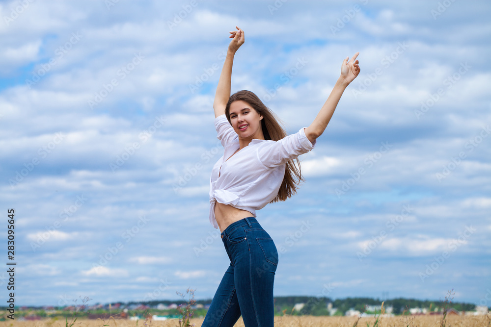 Young brunette woman in white shirt and blue jeans shorts Young brunette woman in white shirt and blue jeans shorts