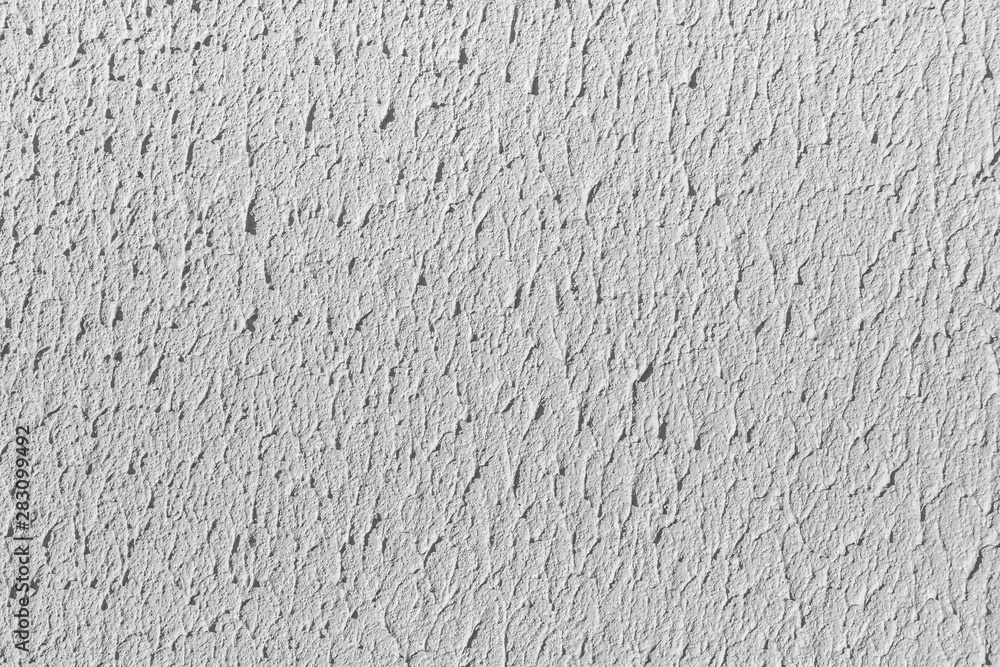 Fototapeta premium Beautiful horizontal texture of part of old concrete wall painted in gray and white color and with holes on the photo