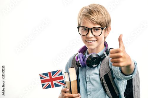 Smiling english schoolboy shows thumbs up