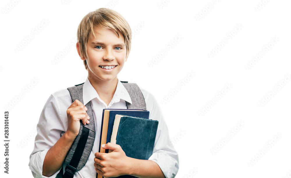 Blond happy schoolboy carrying books and schoolbag Blond happy schoolboy carrying books and schoolbag