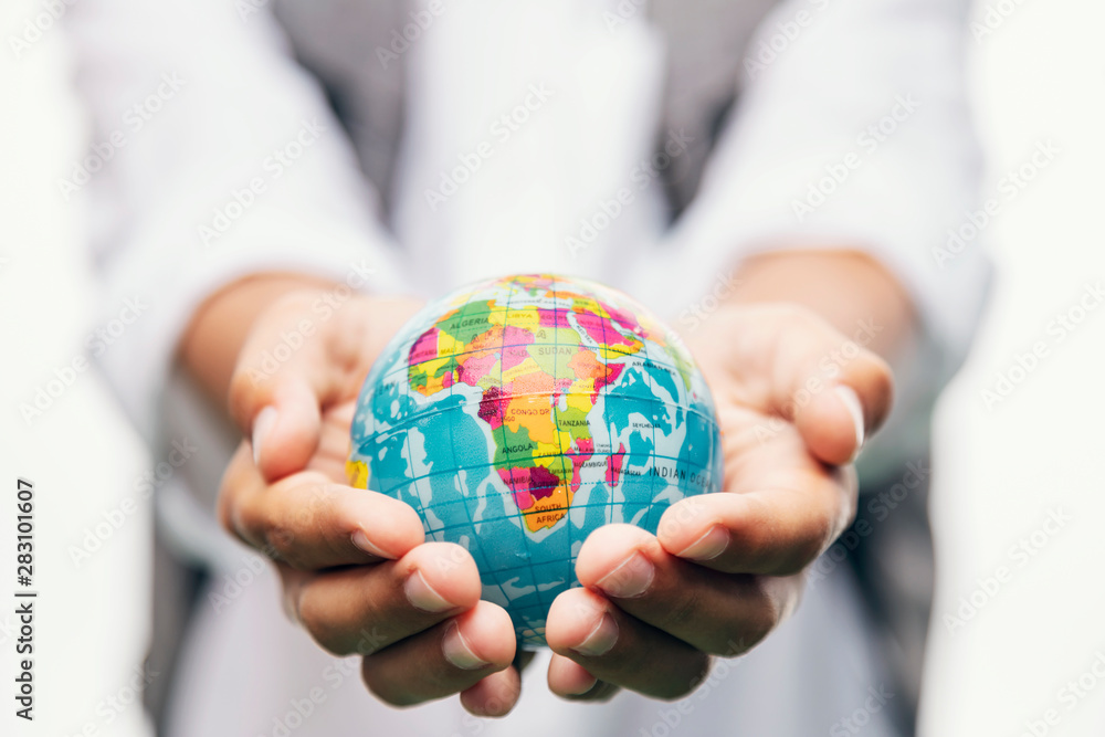 Blurred kid holding a globe in stretched hands closeup Blurred kid holding a globe in stretched hands closeup