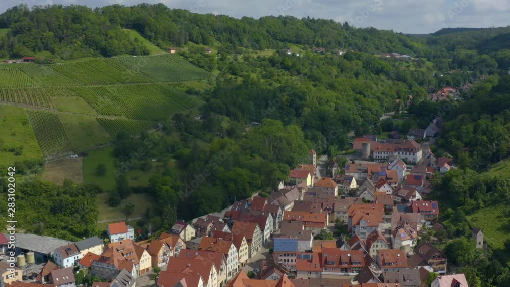 Aerial view from the old part of the city Ingelfingen in Germany. Wide shot with hillside. Camera tilts down slowly to the center of town and New Palace Ingelfigen. Aerial view from the old part of the city Ingelfingen in Germany. Wide shot with hillside. Camera tilts down slowly to the center of town and New Palace Ingelfigen.