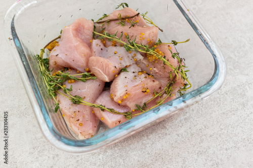 Raw turkey slices with thyme and mustard marinade ready to bake or grill