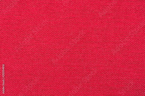 Rough red fabric texture for background and design. Soft focus