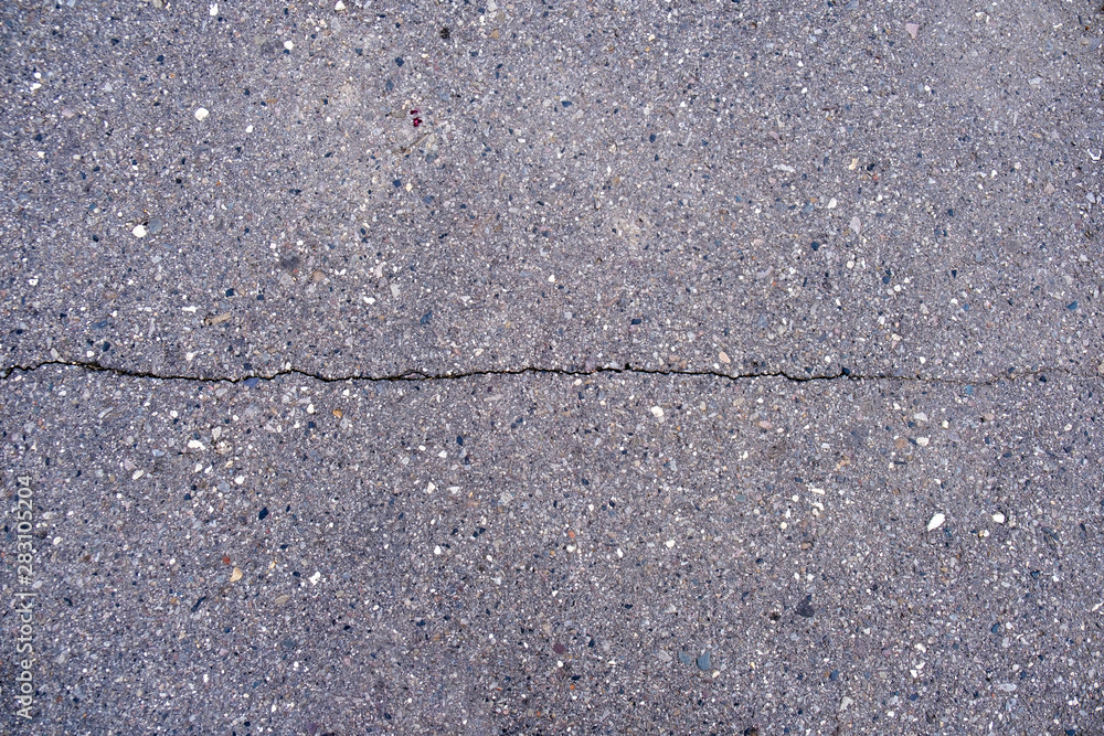 Obraz premium narrow long crack in asphalt