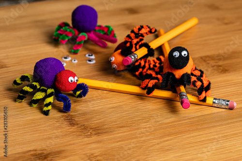 Fun Halloween Crafts.  Spiders made of pom poms and pipe cleaners.  Attach to pencils.
