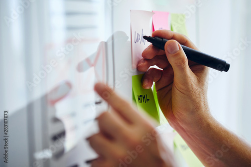 Web designer planning website ux app development on white board