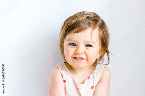 Happy smiling funny toddler child girl on white background