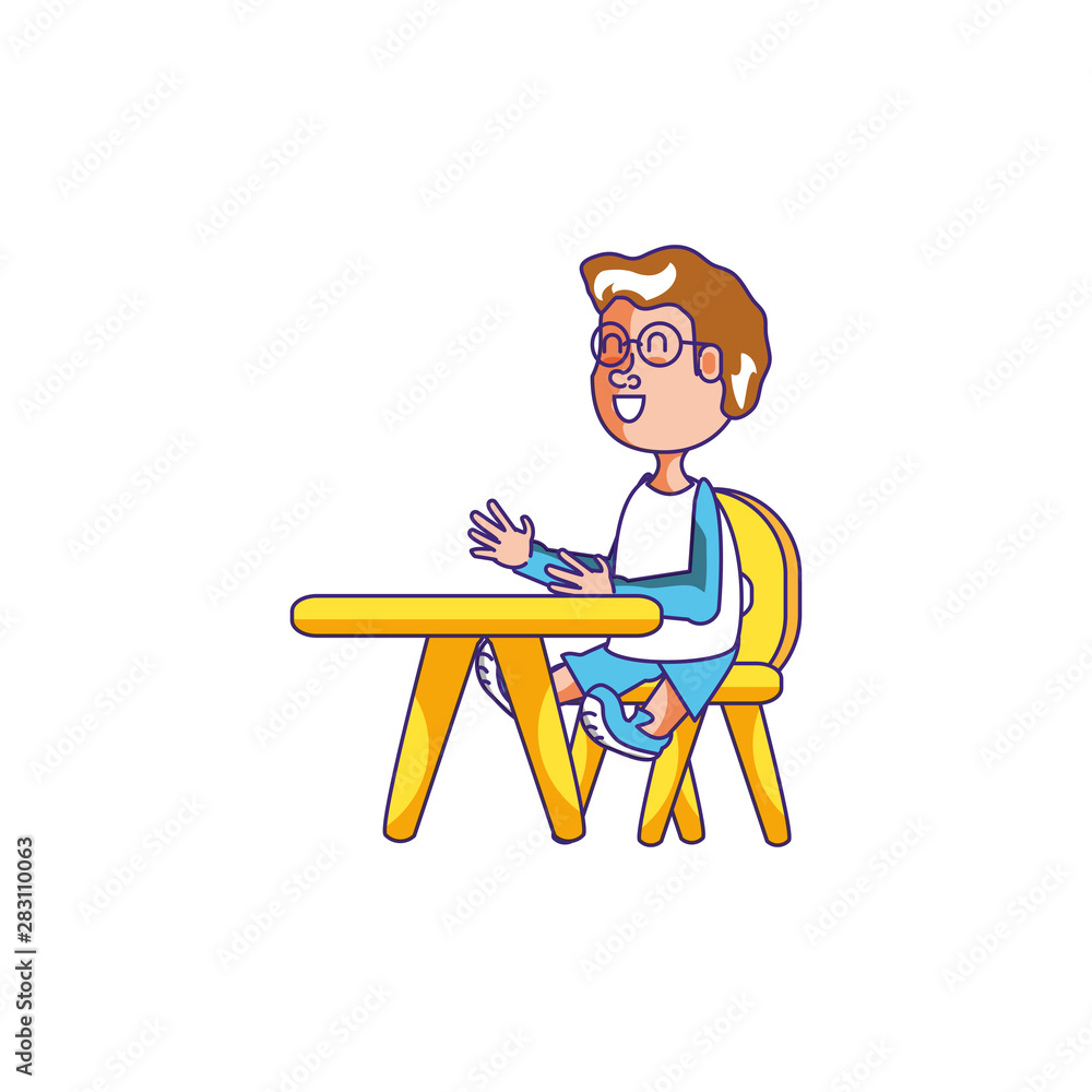 little student boy sitting in school desk