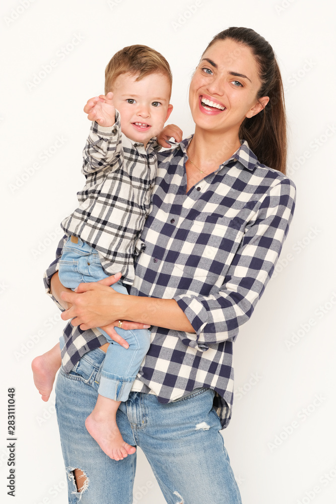 Pretty mom with handsome son weared in checked shirt on white background. Pretty mom with handsome son weared in checked shirt on white background.