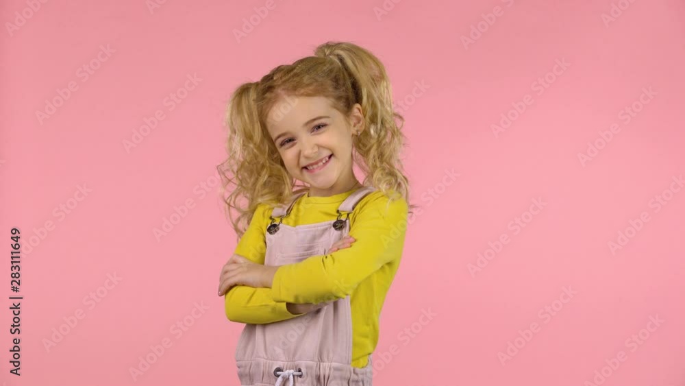 Pretty young female is pointing to something with her fingers