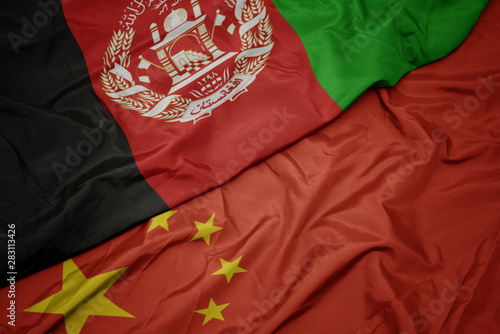 waving colorful flag of china and national flag of afghanistan.