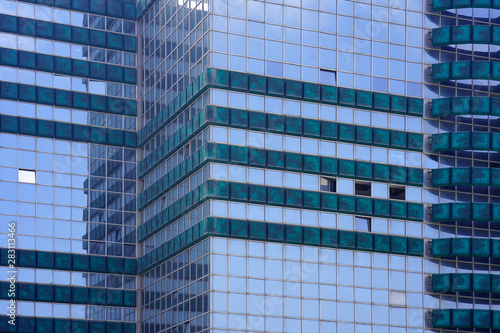 Glass blue square Windows of facade modern city business building skyscraper. Modern apartment buildings in new neighborhood. Windows of a building, texture.
