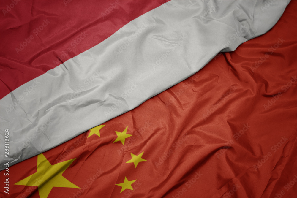 waving colorful flag of china and national flag of indonesia. waving colorful flag of china and national flag of indonesia.
