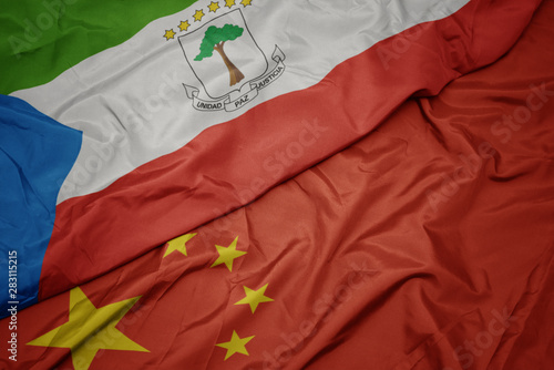waving colorful flag of china and national flag of equatorial guinea.