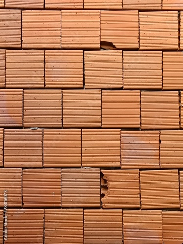 brick wall of red color, wide panorama of masonry. Common house brick isolated on white background.
