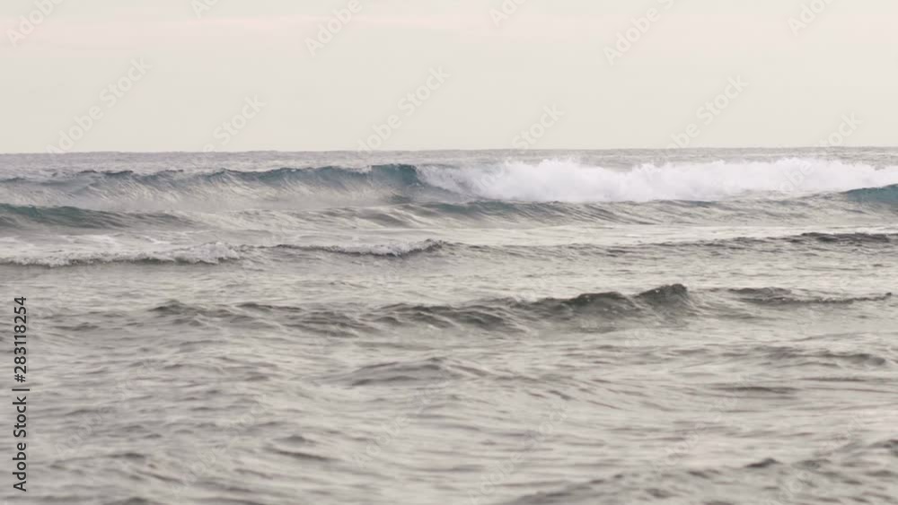 Slow motion view of waves breaking near the seashore at early morning. Slow motion view of waves breaking near the seashore at early morning.