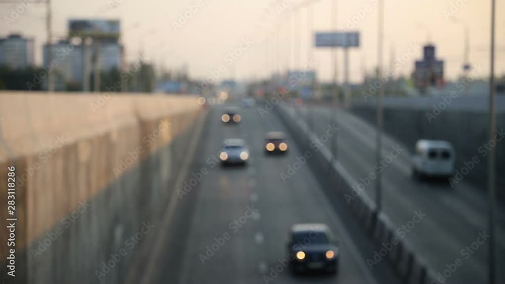 view of urban car traffic early in the morning, defocus makes beautiful bokeh from the included headlights, general plan view of urban car traffic early in the morning, defocus makes beautiful bokeh from the included headlights, general plan