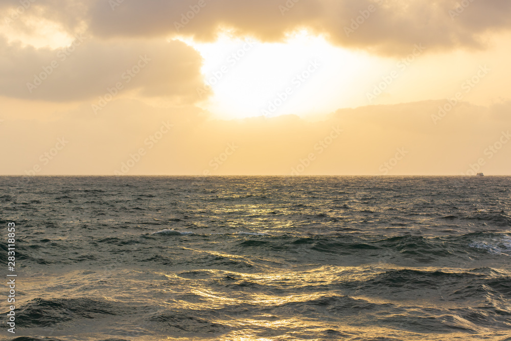 simple beautiful scenic landscape background photography of evening sunset cloudy weather above Caribbean sea wavy water surface to horizon 