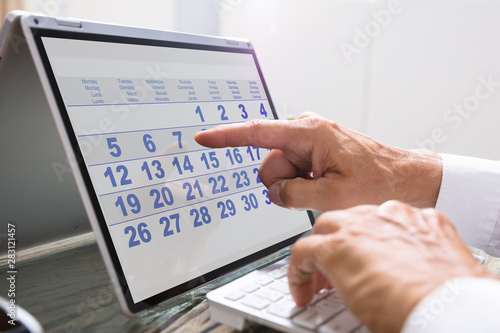 Businessman Using Calendar On Laptop