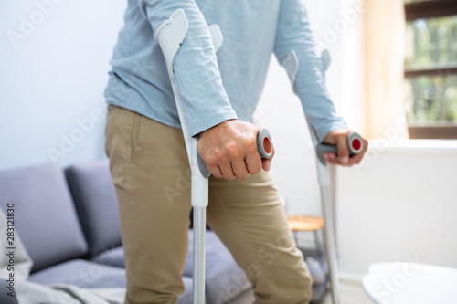 Fotografia Disabled Man Using Crutches To Walk