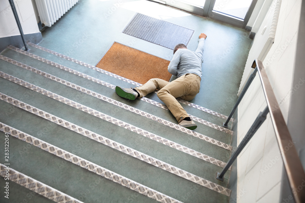 Unconscious Man Lying On Staircase - obrazy, fototapety, plakaty 
