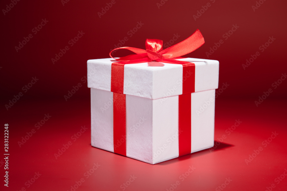 White gift box on red background. Copy spase