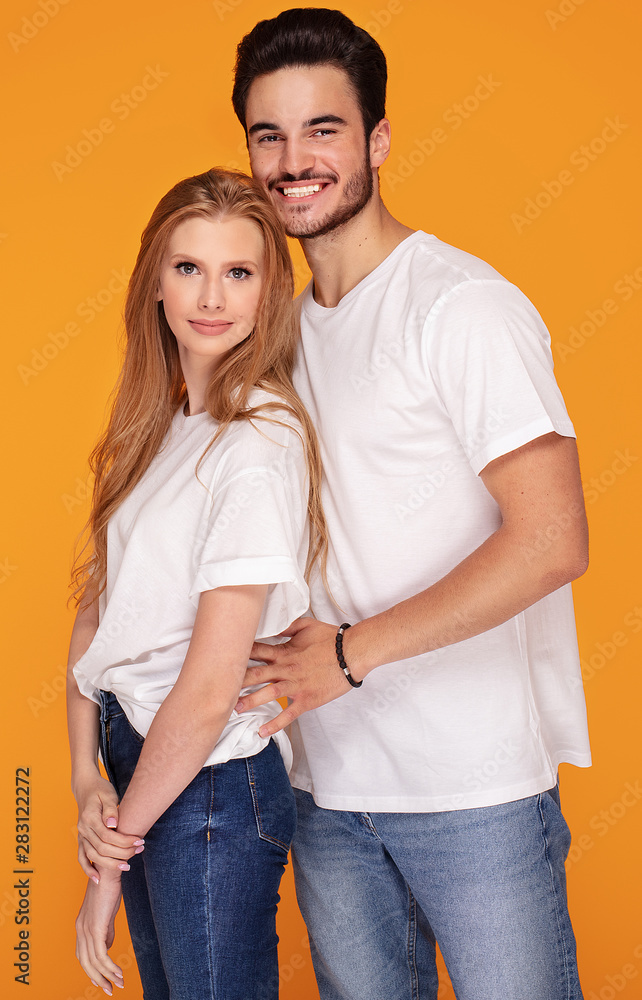 Happy young couple posing in studio. Happy young couple posing in studio.