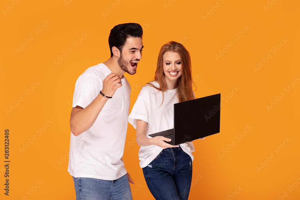 Happy youg couple posing together in studio. Happy youg couple posing together in studio.