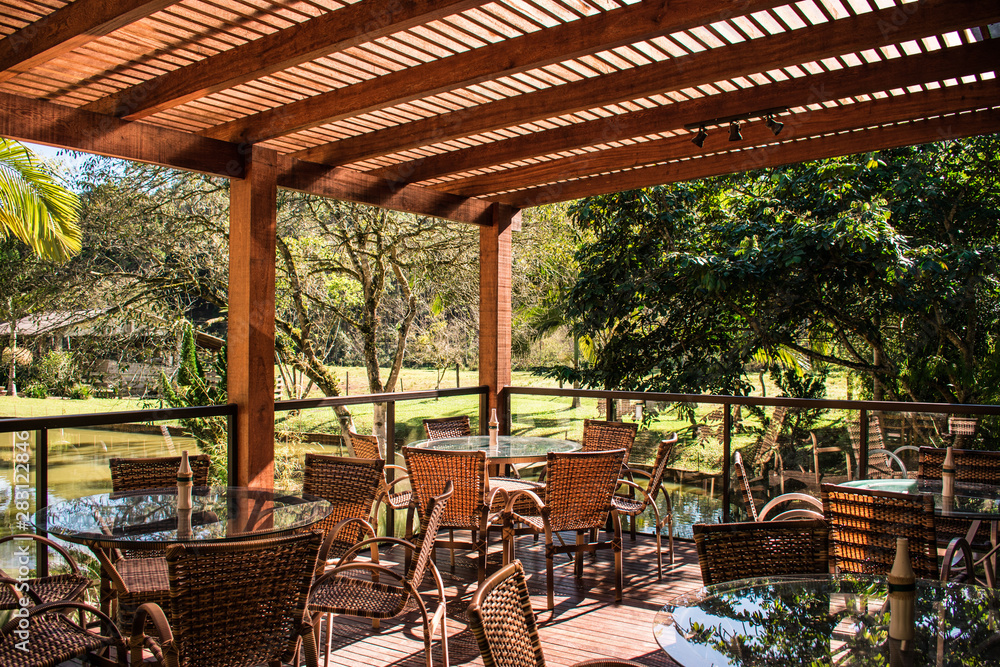 Fototapeta premium wood pergola and tables in garden farm