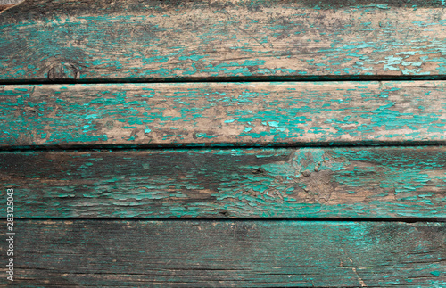 Background in the form of four horizontal wooden boards of dirty green color with peeling paint