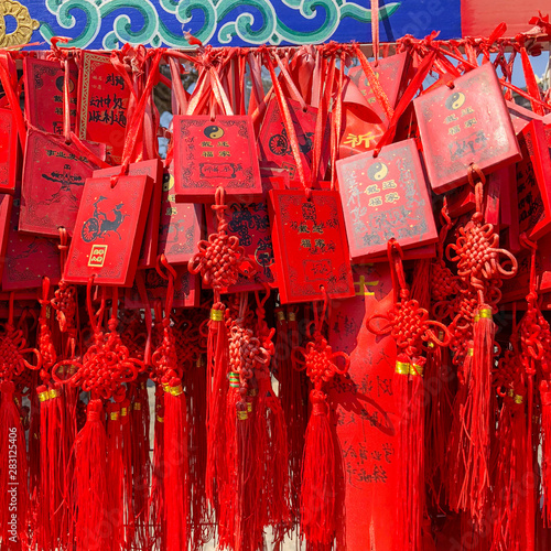 Red buddhists praying and hanging traditional wishing cards at the Dongyue Temple in Beijing, China photo